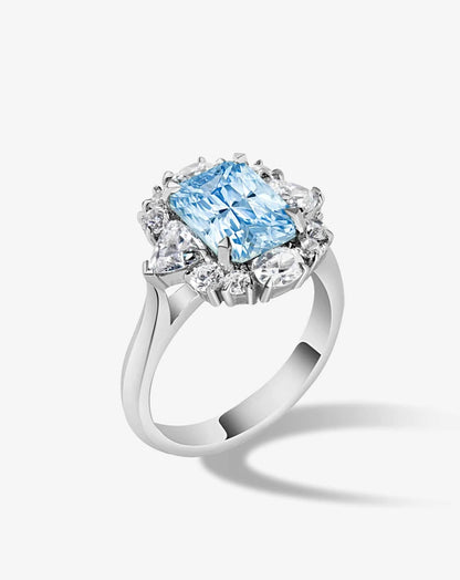 Anillo de compromiso con lab-grown diamond fancy azul 2.00 ct corte radiant con halo de diamantes.